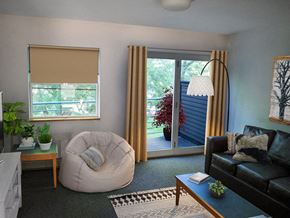 Burlington apartment for rent - a living room with a couch and a chair and a sliding glass door