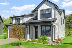 Woodbury apartment for rent - a gray house with a garage and a lawn