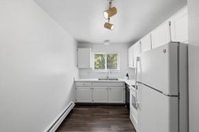Royal Oak apartment for rent - A kitchen with white cabinets and a white refrigerator.