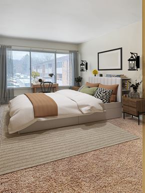 Kalamazoo apartment for rent - A bedroom with a large bed and a window overlooking a parking lot.