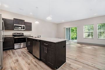 Holland apartment for rent - A kitchen with dark wood cabinets and a white countertop.