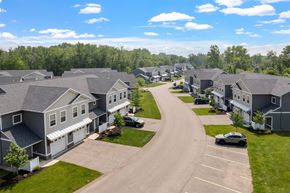 Holland apartment for rent - A residential area with houses and a car parked in the driveway.