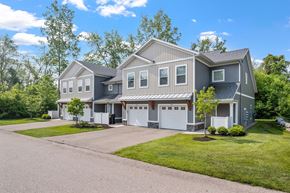 Holland apartment for rent - A large house with a grey roof and a white garage door.