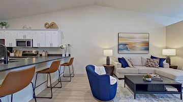 Independence apartment for rent - A modern living room with a blue chair and a grey couch.