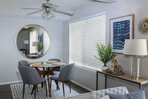 Wheeling apartment for rent - a dining room with a round table and a ceiling fan