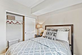 Westerville apartment for rent - A bedroom with a bed, a lamp, and a pillow that says "You can have it all".