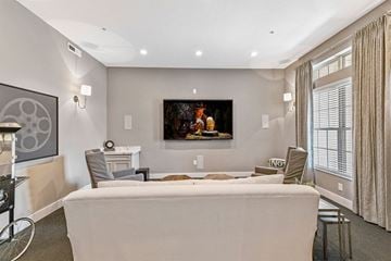 Westerville apartment for rent - A living room with a grey couch and a painting on the wall.