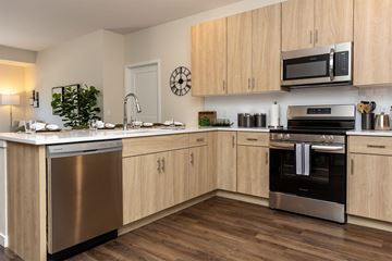 Apple Valley apartment for rent - A modern kitchen with wooden cabinets and stainless steel appliances.