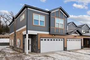 Inver Grove Heights apartment for rent - A modern house with a grey and brown exterior and a white garage door.