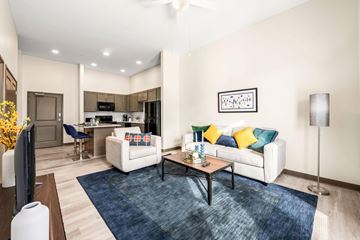 Cleveland apartment for rent - A living room with a white couch and a coffee table.