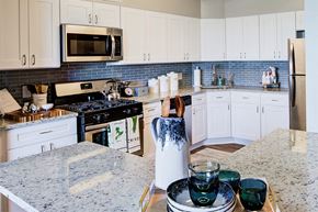 Beachwood apartment for rent - a kitchen with white cabinets and a counter top