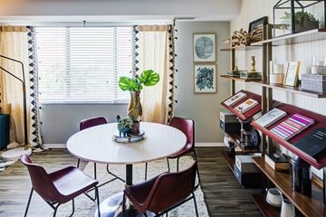 Beachwood apartment for rent - a living room with a table and chairs and a piano