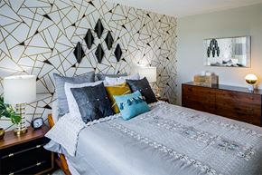 Beachwood apartment for rent - a bedroom with a bed and a geometric wallpaper
