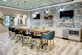 Beachwood apartment for rent - a dining room with a table and chairs and a television