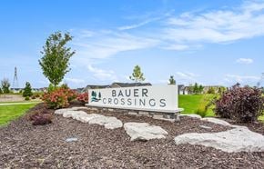Hudsonville apartment for rent - A sign that says Bauer Crossings is in front of a grassy area.