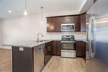 Hudsonville apartment for rent - A modern kitchen with wooden cabinets and stainless steel appliances.