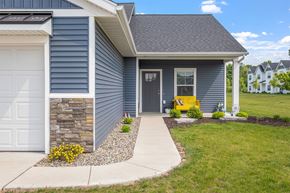 Hudsonville apartment for rent - A house with a grey exterior and a white garage door.
