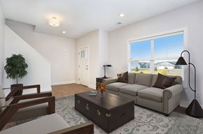 Hudsonville apartment for rent - A living room with a brown couch, a coffee table, and a lamp.
