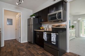 Mason apartment for rent - kitchen with dark wood cabinets and stainless steel appliances