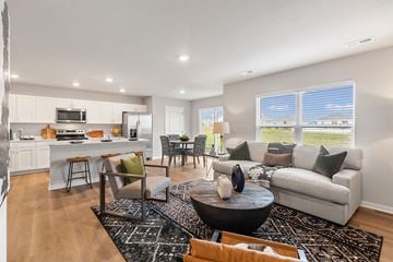 Ankeny apartment for rent - A modern living room with a black coffee table and a white couch.