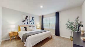 Ankeny apartment for rent - A bedroom with a bed, nightstand, and a painting on the wall.