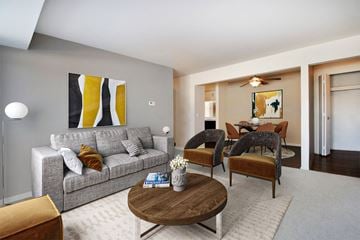 Bloomfield Hills apartment for rent - A living room with a grey couch, a coffee table, and a painting on the wall.