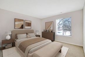 Bloomfield Hills apartment for rent - A bedroom with a large bed and two lamps on side tables.