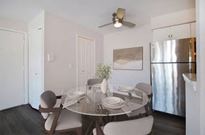 Bloomfield Hills apartment for rent - A modern dining room with a glass table and chairs.