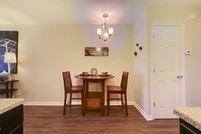 Little Rock apartment for rent - A dining room with a wooden table and chairs.