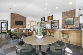 Rogers apartment for rent - A modern dining room with a round table and chairs.