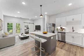 Rogers apartment for rent - A modern kitchen with a white island and stainless steel appliances.