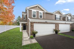 Hobart apartment for rent - A house with a brown and white exterior and a garage door.
