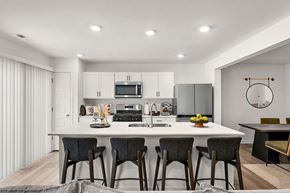 Hobart apartment for rent - A modern kitchen with a dining table and chairs.
