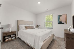 Hobart apartment for rent - A bedroom with a large bed and a window with blinds.