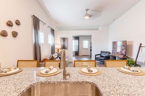 O'fallon apartment for rent - A kitchen with a sink, counter and chairs.