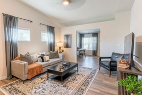 O'fallon apartment for rent - A living room with a couch, chair, and television.