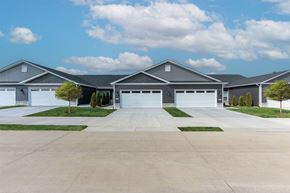 O'fallon apartment for rent - A large, modern house with a grey roof and multiple garages.