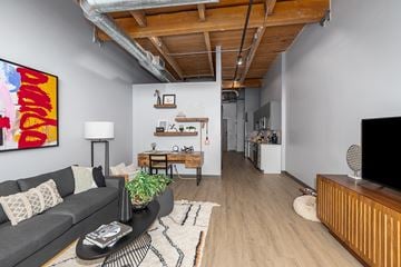Grand Rapids apartment for rent - A living room with a grey couch and a wooden coffee table.