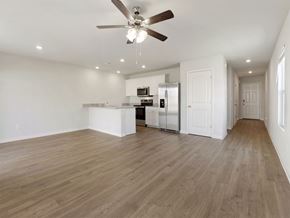 Byhalia apartment for rent - A spacious room with a ceiling fan and wooden flooring.