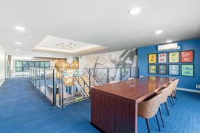 Richfield apartment for rent - A conference room with a long table and chairs, a blue carpet, and a wall with a map of the world.