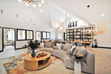 Livonia apartment for rent - A living room with a grey couch and a wooden coffee table.
