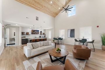 Crown Point apartment for rent - A living room with a white couch and brown chairs.