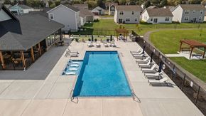 Crown Point apartment for rent - A large swimming pool surrounded by lounge chairs and a pavilion.