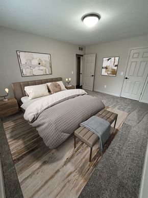 Farmington Hills apartment for rent - A bedroom with a bed, nightstands, and two doors.