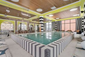 Cincinnati apartment for rent - A large indoor swimming pool with a striped tile border.
