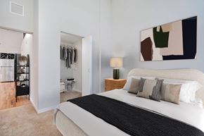 Cincinnati apartment for rent - A bedroom with a large bed and a painting on the wall.