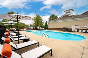 Westerville apartment for rent - outdoor pool with lounge chairs and umbrellas