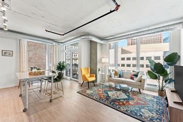 Cleveland apartment for rent - a living room with a couch and a table and a large window