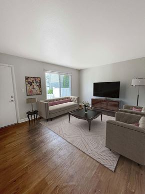 East Lansing apartment for rent - A living room with a couch, chair, and coffee table.