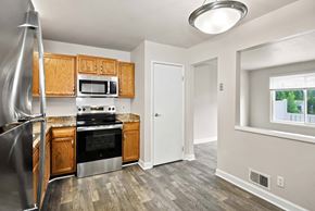 East Lansing apartment for rent - A kitchen with wooden cabinets and stainless steel appliances.